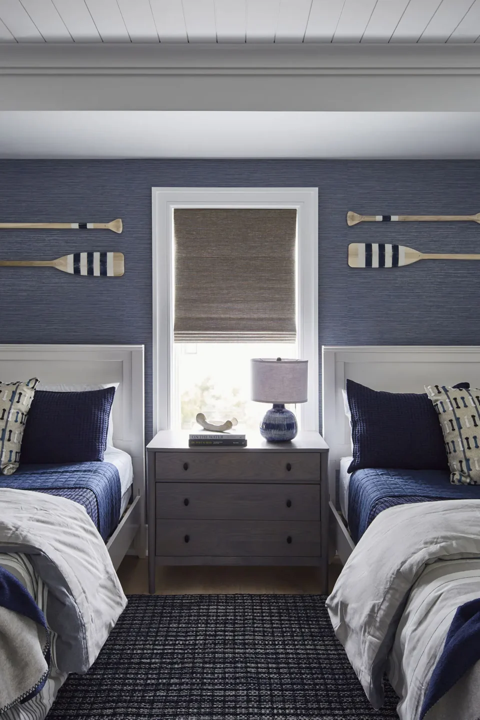 Beds With Antique Oars Hangning Over Headboards