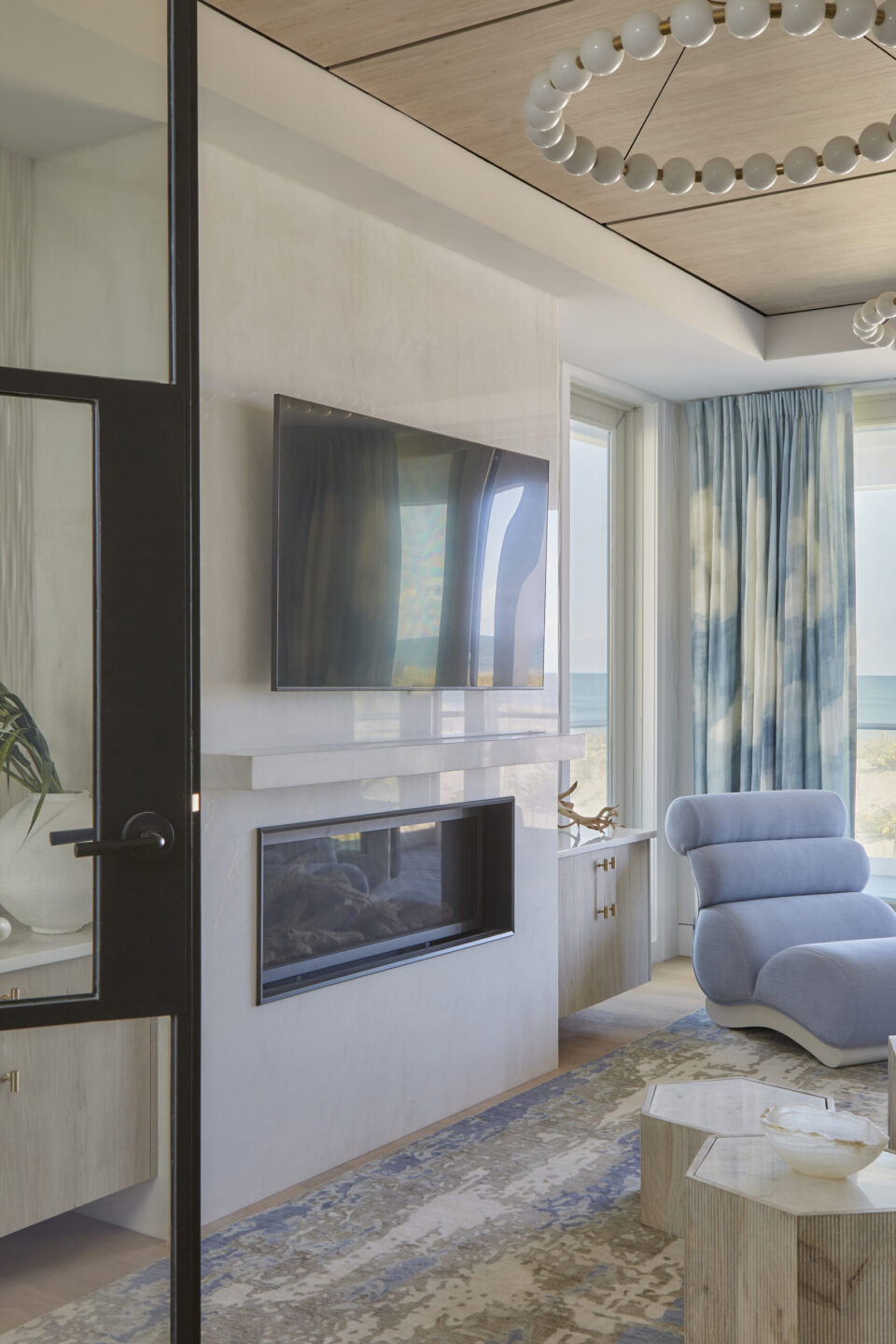 Gas Fireplace With Tv And Blue Accent Chair