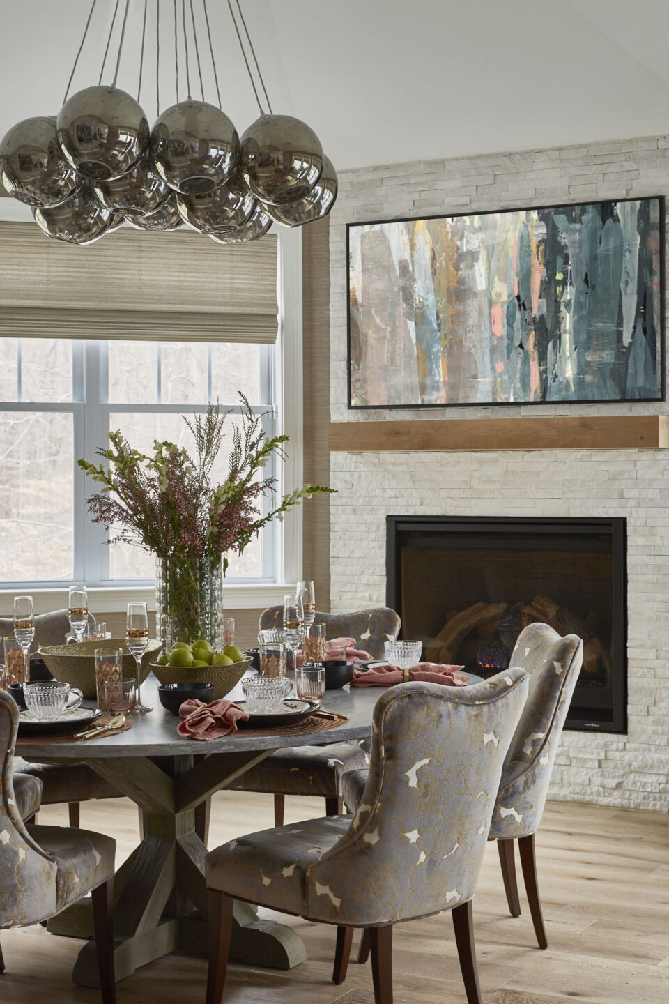 Round Dining Table And White Stone Fireplace