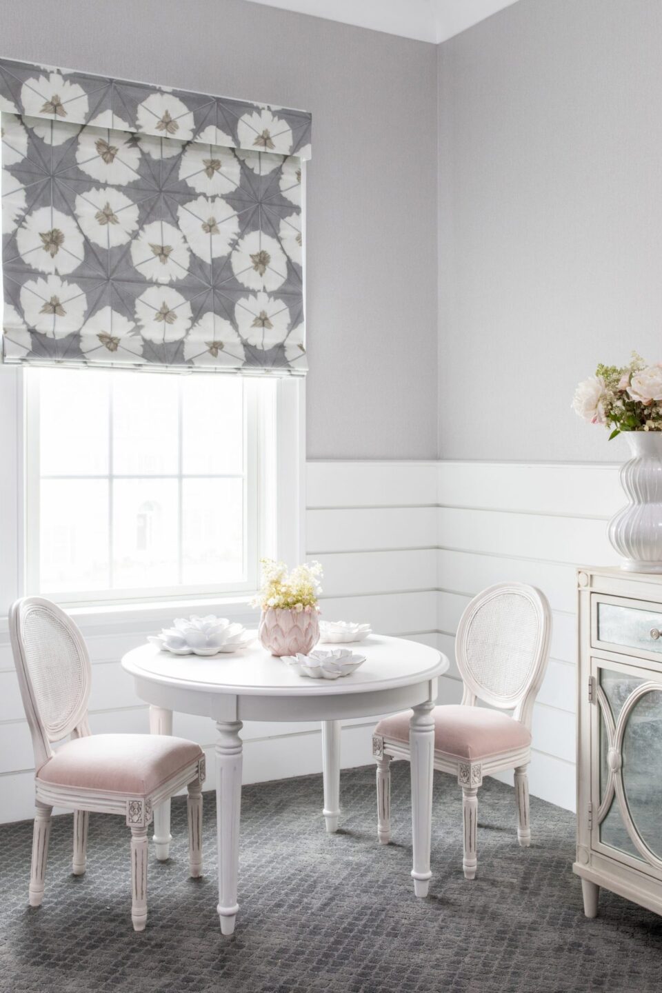 Round White Table With Pink And White Chairs